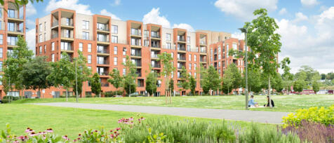 Redrow-built modern apartment complex with green communal gardens and walking paths, with two women