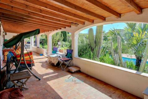 large covered terrace overlooking swimming pool