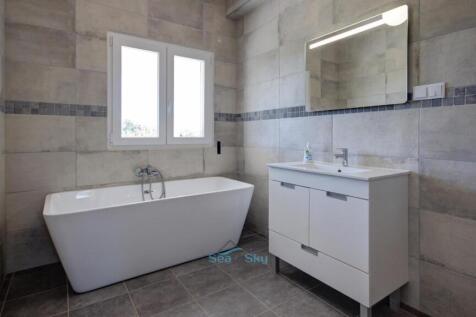 ensuite bathroom with soaker bathtub
