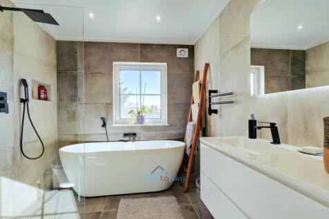 shared bathroom with soaker tub and walk in shower