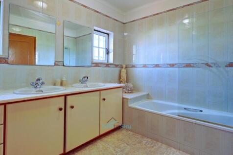 shared bathroom with twin sinks