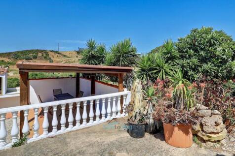 adjacent to the barbecue pergola