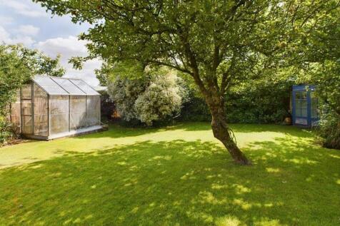 Bottom of the garden with greenhouse