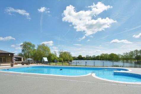 Outdoor pool with lake behind