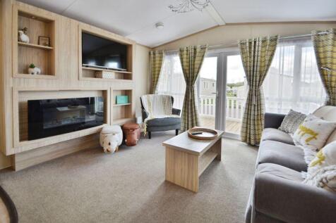 Living room with doors out to the dec...