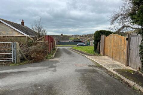 Land looking own roadway showing both vehicle acce