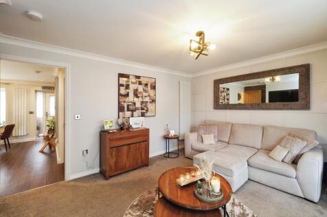 Spacious yet Cosy Living Room with French Doors and Feature Media Wall and Fire