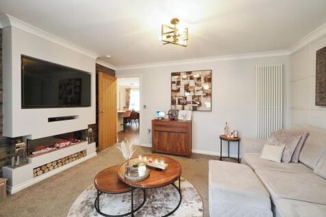 Spacious yet Cosy Living Room with French Doors and Feature Media Wall and Fire