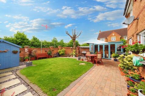 Fantastic and well loved garden space with summer house/potting shed, patio and storage shed