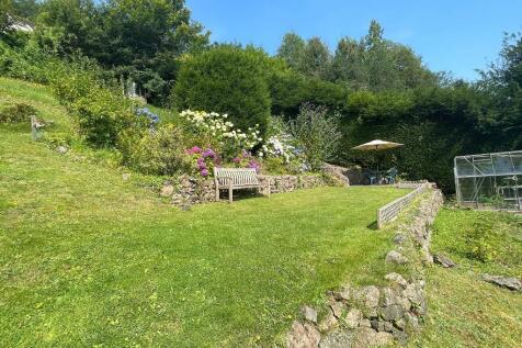 Lovely summer garden with greenhouse