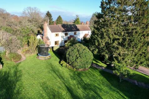 With mature trees and lawn garden