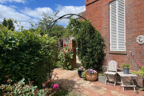 Archway to parking and front door