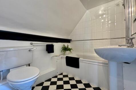 Family bathroom with shower over