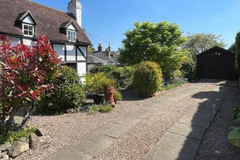 Driveway parking plus wooden outbuilding