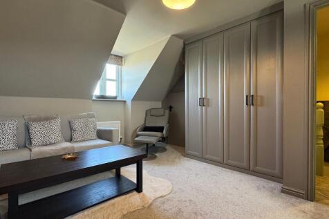 Sofa area and wardrobes to Bed 1