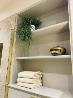 Useful fitted shelving in shower room