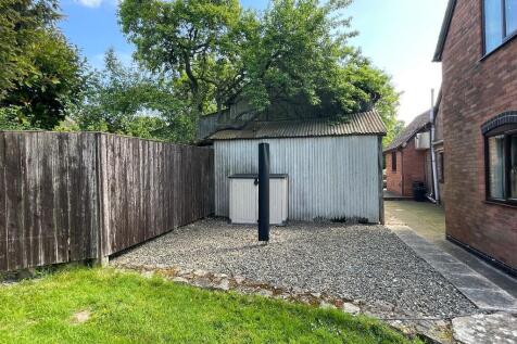 Barn located beyond the corrugated iron