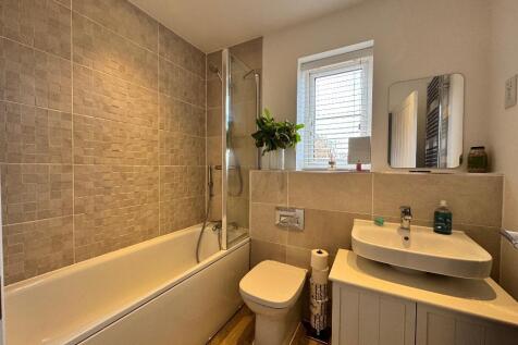 Family bathroom with shower over