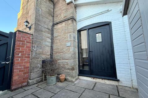 Front door to cottage at the side