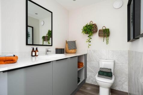 A guest cloakroom also hosts space for laundry appliances