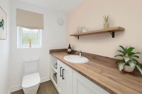 A guest cloakroom with space for laundry appliances makes the most of the layout
