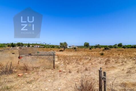 Farm with large urban plot with ruin and extensive flat land, in Burgau - Luzi Homes