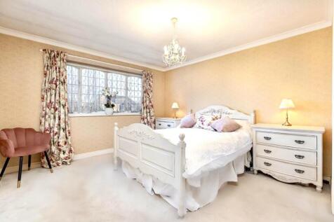 bedroom with pink chair in corner.jpg