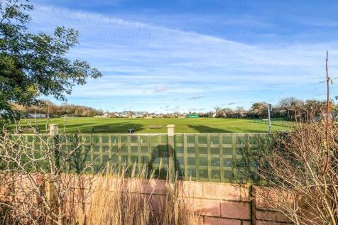 Backing onto Cricket field