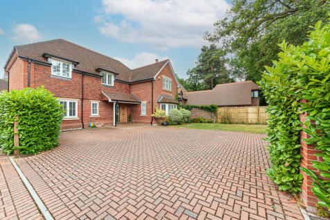 Front aspect with large driveway
