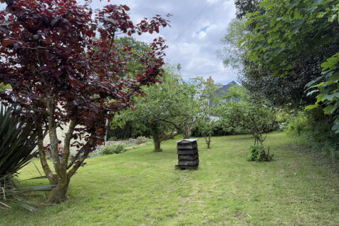Gardens to front/side with mature fruit trees