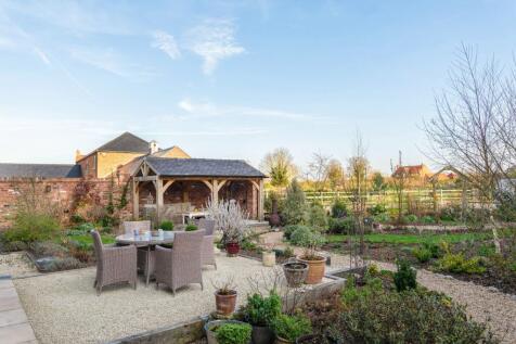 Cleverly zoned seating areas in the south facing garden at The Barn