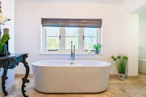 Freestanding tub in the bright Master Bathroom
