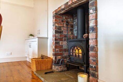 Warm up by the log burner in the dining room