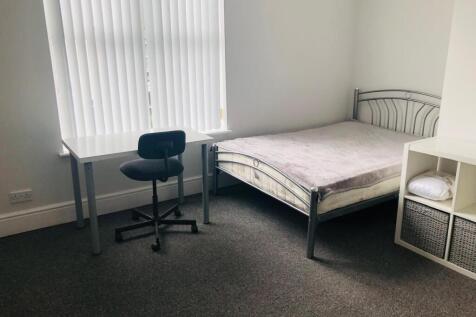 Bedroom with desk and widow.JPG