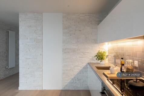Open Plan Kitchen Area With Stone Feature Wall