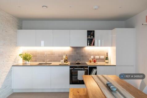 Open Plan Kitchen Area With Stone Feature Wall