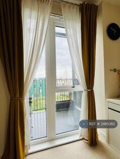 Bedroom With View Of Balcony &amp; Garden