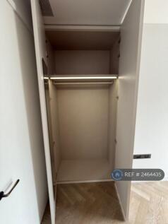 Fitted Closet In Bedroom With Lights
