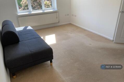 One End Of Spacious Living Room With Bed Settee