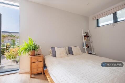 Bedroom With Open Door To Balcony