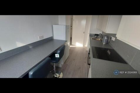 Kitchen With Breakfast Bar And Stools