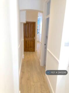 Hallway With Storage Area Under Stairs