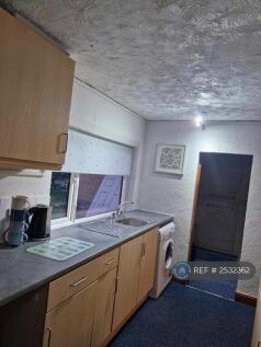 Kitchen Leading Into Bathroom And Living Room
