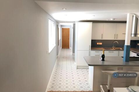 a Beautifully Tiled Hallway Leads To Kitchen Area