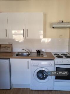 Kitchen With Washing Machine, Oven And Fridge 