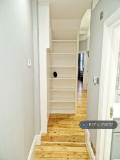 Built-In Bookshelves And Housed Utility Meters 