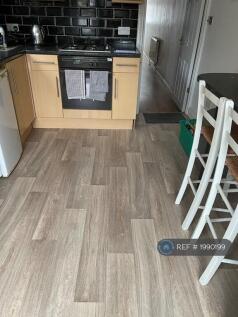 Kitchen Has a Breakfast Bar With 2 Stools