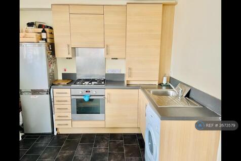 Kitchen Furnished With Washing Machine And Fridge