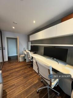 Two Workspaces With Wide Screen Monitors