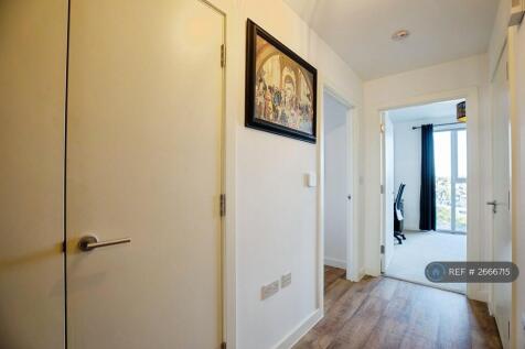 Hallway With Utility Cupboard On Left